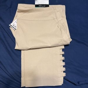Khaki pants, comes to mid calf, opening/gems on side of calf. Never worn has tag